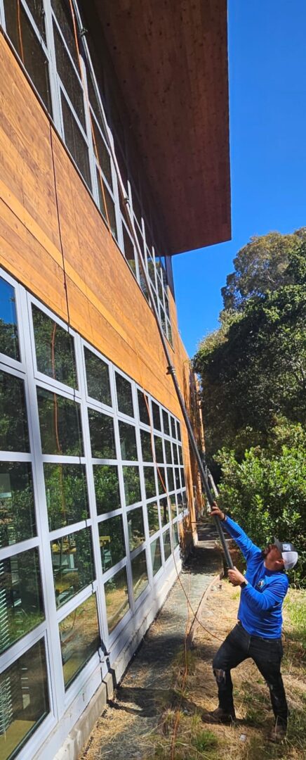 A Man Wiping Windows With A Wiper